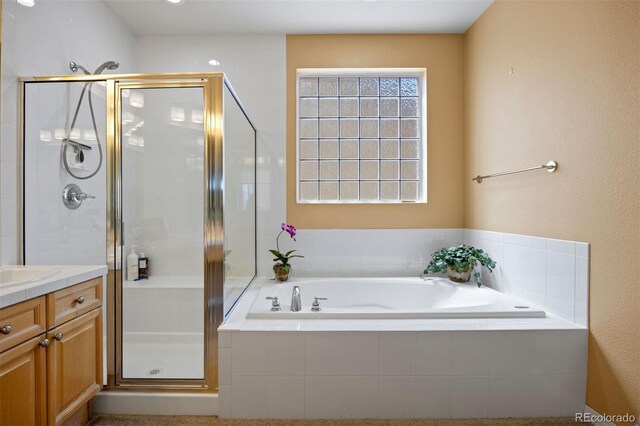 4373 E Phillips Pl, Centennial, CO 80122 - bathroom featuring vanity, a bath, and a stall shower