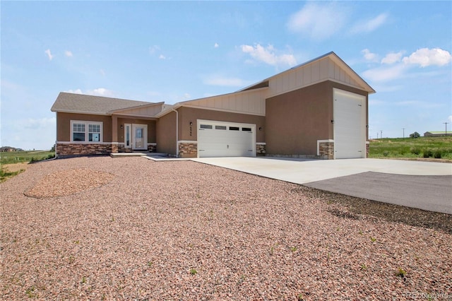 6986 Marshbern Ct, Colorado Springs, CO 80908 - view of front of house featuring stone siding, driveway, a garage, and stucco siding