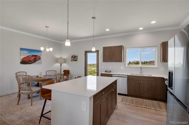 6986 Marshbern Ct, Colorado Springs, CO 80908 - kitchen with dishwasher, a breakfast bar area, stainless steel fridge with ice dispenser, light countertops, and a center island