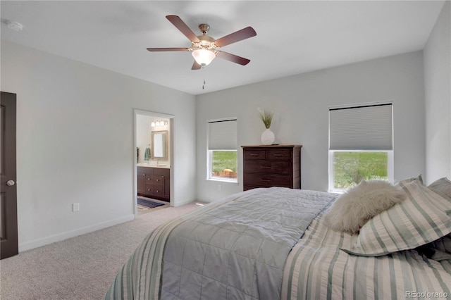 6986 Marshbern Ct, Colorado Springs, CO 80908 - bedroom featuring light colored carpet, multiple windows, a ceiling fan, and connected bathroom