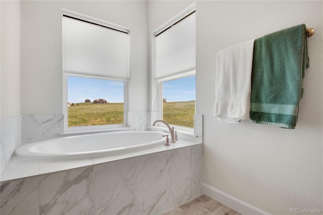 6986 Marshbern Ct, Colorado Springs, CO 80908 - full bathroom with a bath and baseboards