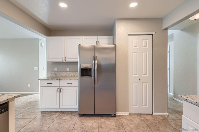 kitchen with appliances with stainless steel finishes, white cabinets, light stone countertops, recessed lighting, and light tile patterned floors