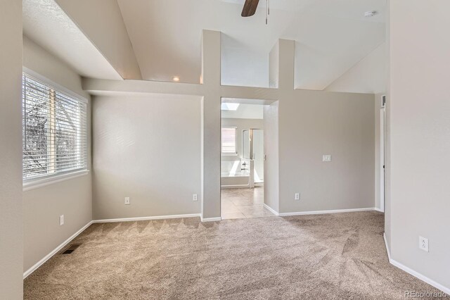 carpeted empty room featuring baseboards and ceiling fan