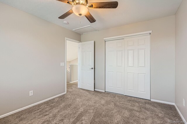 unfurnished bedroom featuring carpet floors, baseboards, and a closet