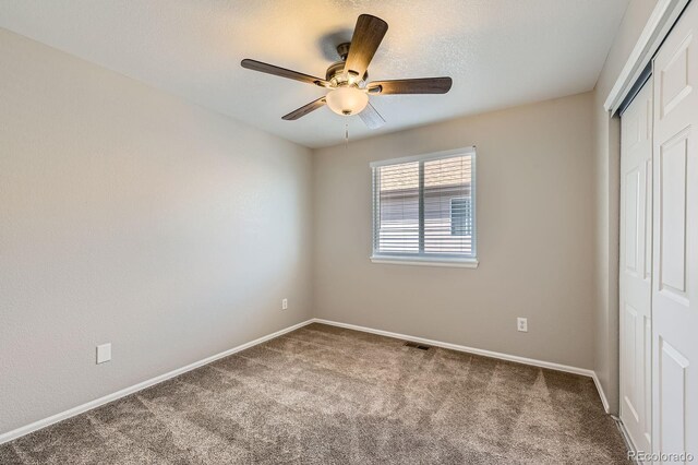 unfurnished bedroom featuring a closet, carpet flooring, and baseboards