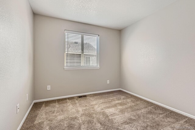 carpeted spare room with baseboards