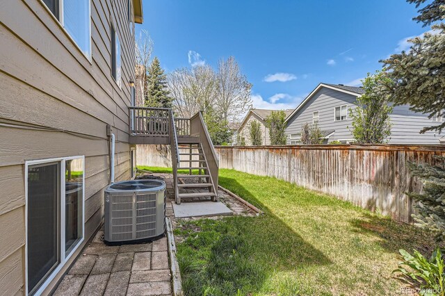 view of yard featuring central AC unit, stairs, and a wooden deck