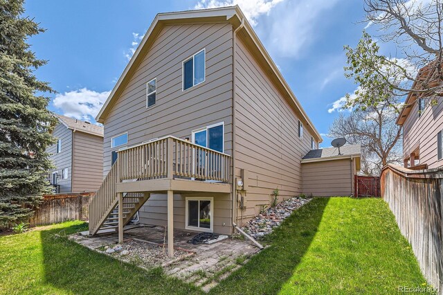 back of property featuring a deck, stairway, and a patio