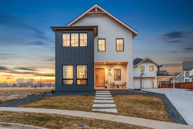 modern farmhouse style home with a yard and a garage