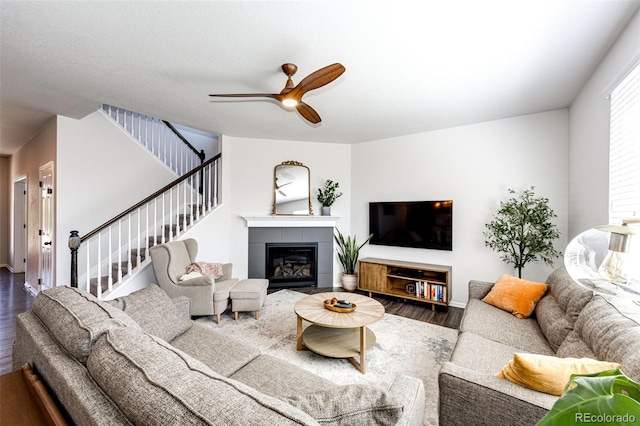 living room with a fireplace, hardwood / wood-style floors, and ceiling fan