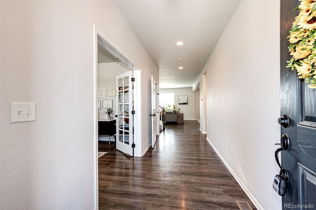 hall featuring french doors and dark wood-type flooring