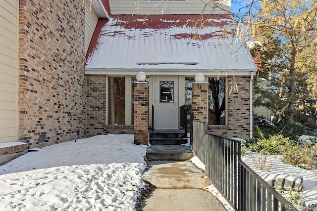 view of snow covered property entrance