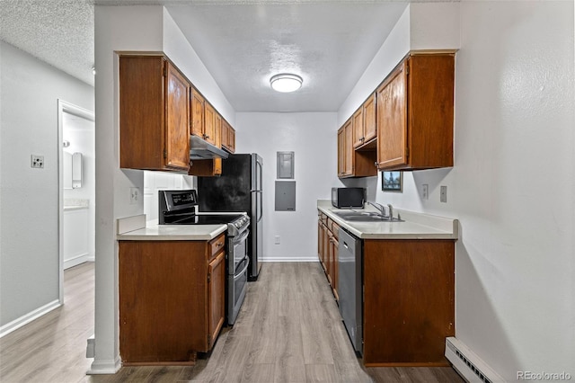 kitchen featuring stainless steel appliances, a baseboard radiator, sink, and a textured ceiling