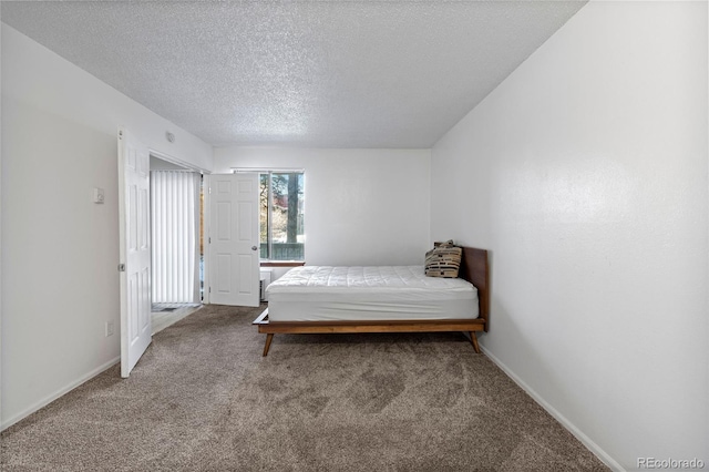 bedroom featuring carpet and a textured ceiling