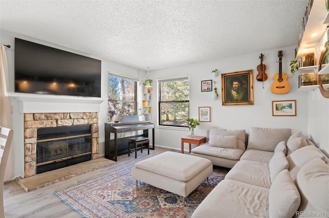 living room featuring hardwood / wood-style flooring, a fireplace, and a textured ceiling