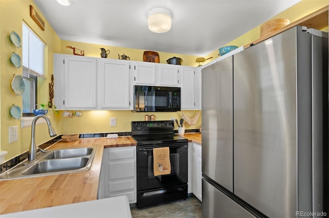 kitchen featuring white cabinetry, sink, black appliances, and wooden counters