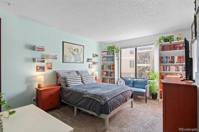 bedroom featuring dark carpet and a textured ceiling