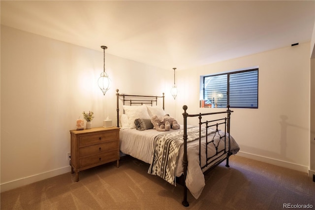 carpeted bedroom featuring baseboards