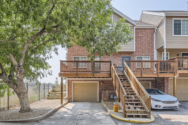 exterior space with a garage and a wooden deck