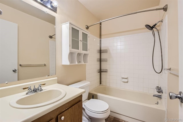 full bathroom with toilet, vanity, and tiled shower / bath