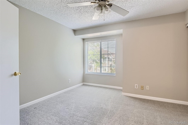 carpeted empty room with a textured ceiling and ceiling fan