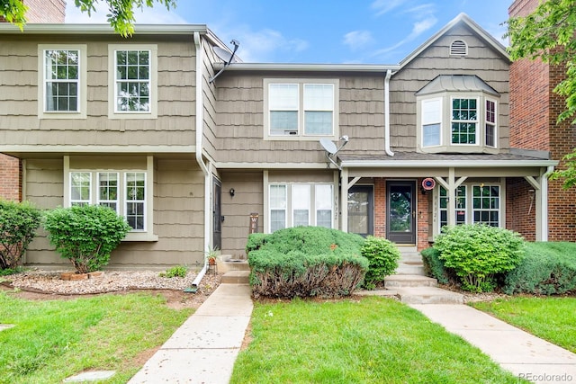 9632 W Chatfield Ave Unit C, Littleton, CO 80128 - townhome / multi-family property with a front yard and brick siding