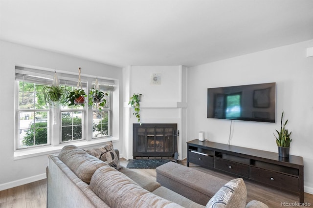 9632 W Chatfield Ave Unit C, Littleton, CO 80128 - living room with plenty of natural light, wood finished floors, baseboards, and a fireplace with flush hearth