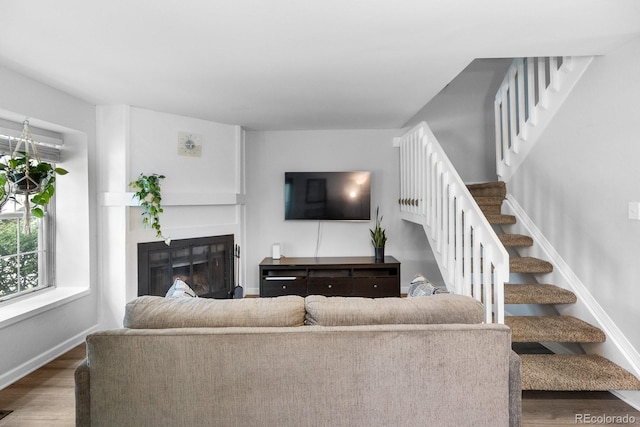9632 W Chatfield Ave Unit C, Littleton, CO 80128 - living area with wood finished floors, stairs, a glass covered fireplace, and baseboards