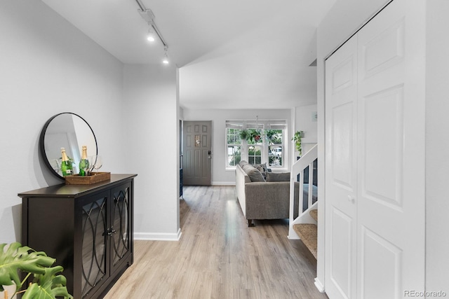 9632 W Chatfield Ave Unit C, Littleton, CO 80128 - hallway featuring light wood-style flooring, track lighting, baseboards, and stairs