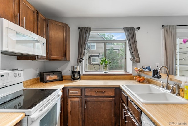 9632 W Chatfield Ave Unit C, Littleton, CO 80128 - kitchen with white appliances, a sink, and light countertops