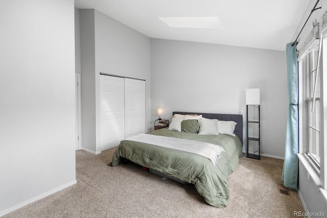 9632 W Chatfield Ave Unit C, Littleton, CO 80128 - bedroom featuring a skylight, carpet floors, vaulted ceiling, a closet, and baseboards