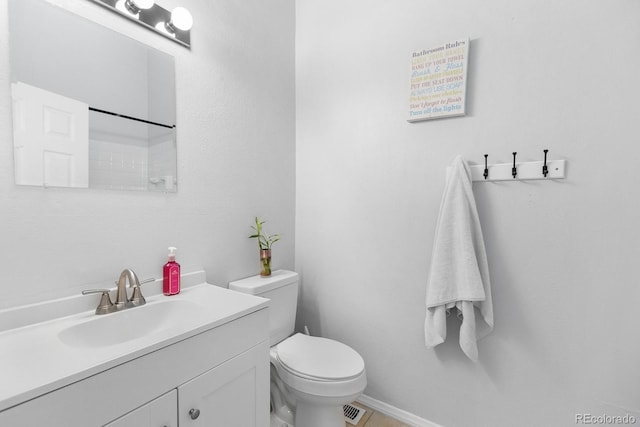 9632 W Chatfield Ave Unit C, Littleton, CO 80128 - bathroom with vanity, toilet, and baseboards