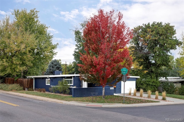 obstructed view of property with a garage