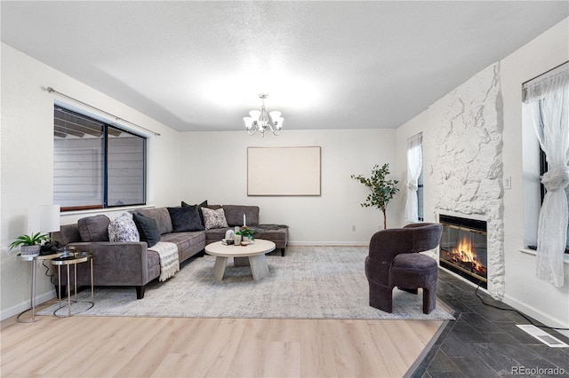 9587 W 89th Cir, Broomfield, CO 80021 - living area featuring a fireplace, a chandelier, and wood finished floors
