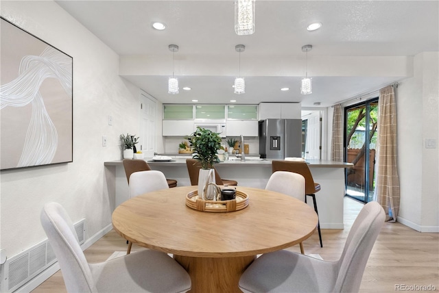 9587 W 89th Cir, Broomfield, CO 80021 - dining room with light wood finished floors and recessed lighting