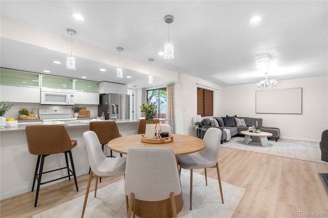 9587 W 89th Cir, Broomfield, CO 80021 - dining space featuring light wood-type flooring, recessed lighting, and a chandelier