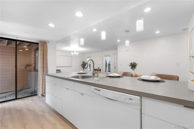 9587 W 89th Cir, Broomfield, CO 80021 - kitchen with white dishwasher, white cabinets, light wood-type flooring, recessed lighting, and hanging light fixtures