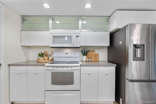 9587 W 89th Cir, Broomfield, CO 80021 - kitchen featuring white appliances, light countertops, white cabinets, recessed lighting, and glass insert cabinets