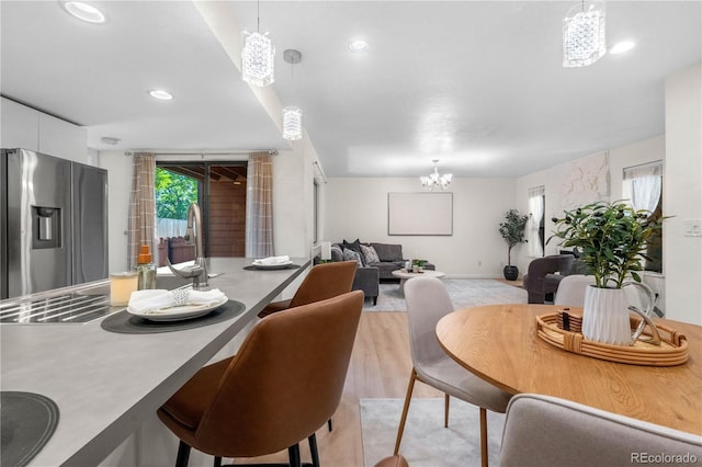 9587 W 89th Cir, Broomfield, CO 80021 - dining space featuring a chandelier, recessed lighting, and light wood-type flooring
