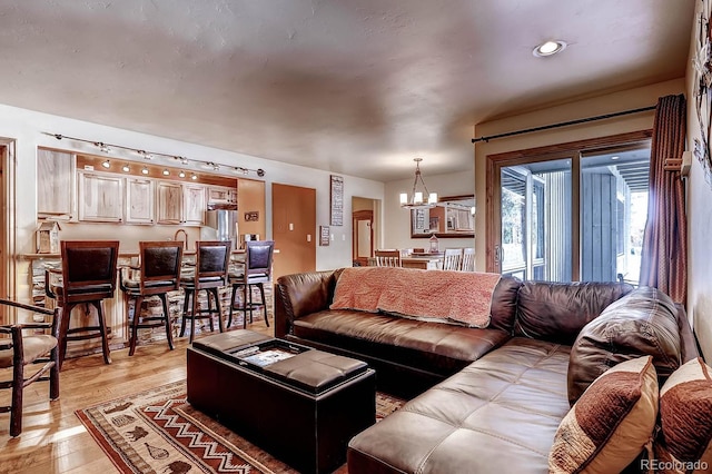 1937 Soda Ridge Rd Unit 1132, Dillon, CO 80435 - living room featuring a chandelier and light wood-style flooring