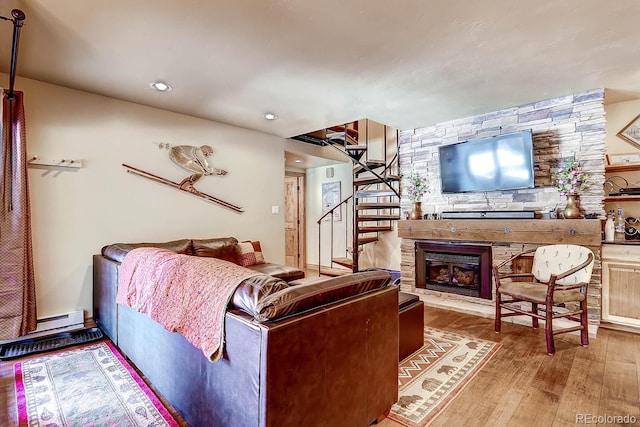 1937 Soda Ridge Rd Unit 1132, Dillon, CO 80435 - living room featuring wood finished floors, stairs, a fireplace, recessed lighting, and a baseboard radiator