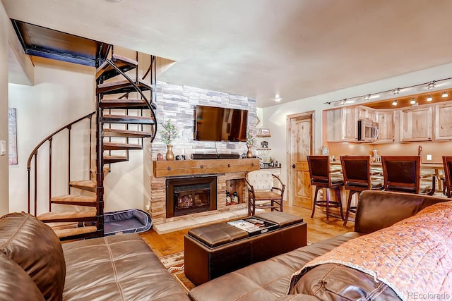 1937 Soda Ridge Rd Unit 1132, Dillon, CO 80435 - living room with stairway, light wood-style flooring, and a fireplace