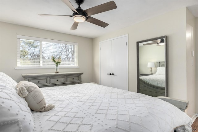 bedroom with a ceiling fan and a closet