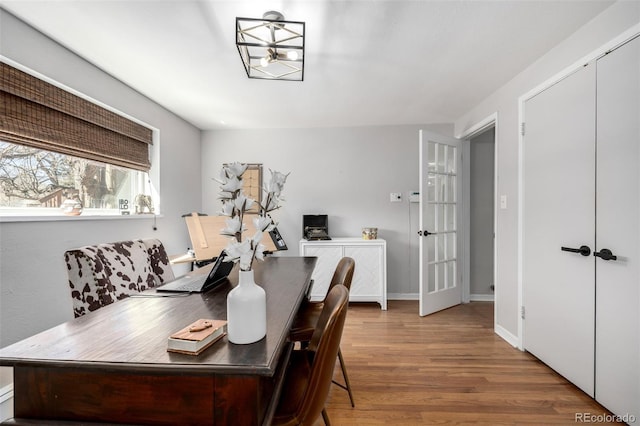 dining room with baseboards and wood finished floors