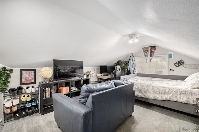 bedroom with lofted ceiling, carpet flooring, and a textured ceiling