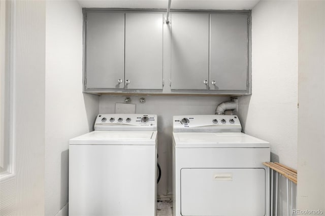 washroom with washing machine and dryer and cabinet space