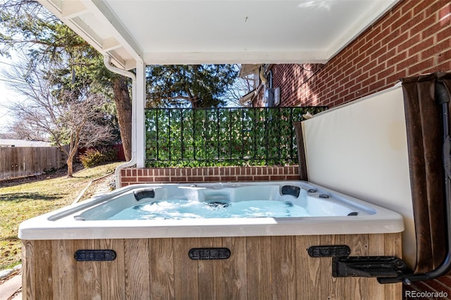 view of patio with fence and a hot tub