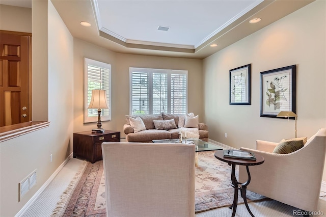 living room with baseboards, recessed lighting, a raised ceiling, and crown molding