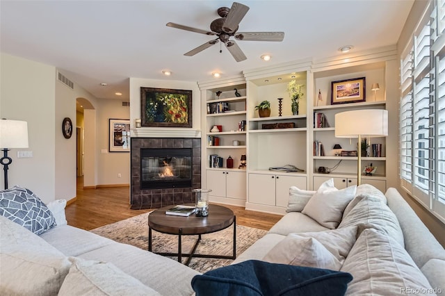 living area featuring arched walkways, wood finished floors, plenty of natural light, ceiling fan, and recessed lighting