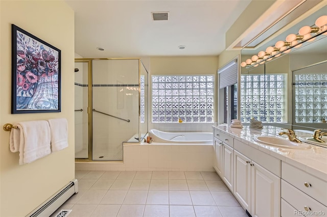 bathroom with baseboard heating, a shower stall, tile patterned flooring, a bath, and vanity